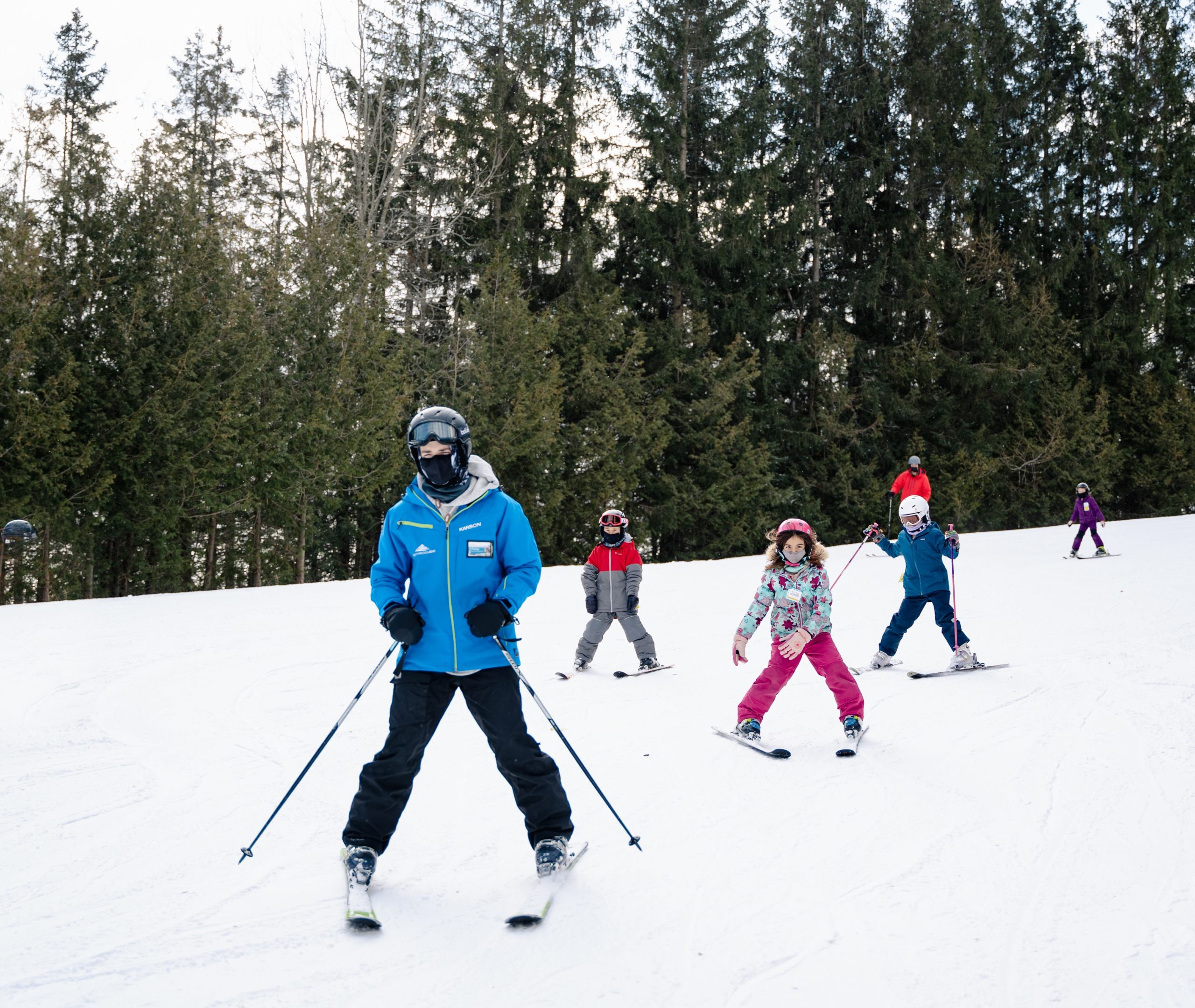ski instructor with a group of kids