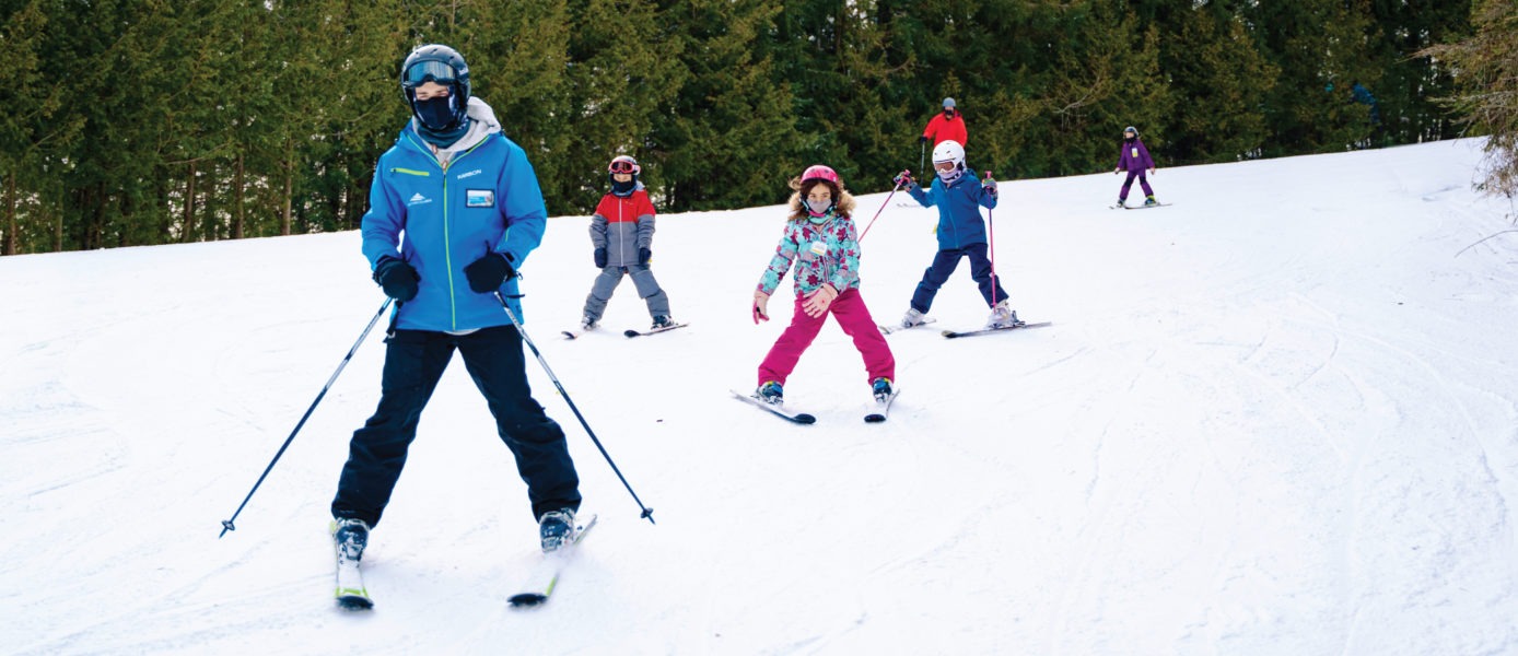 Ski instructor with kids