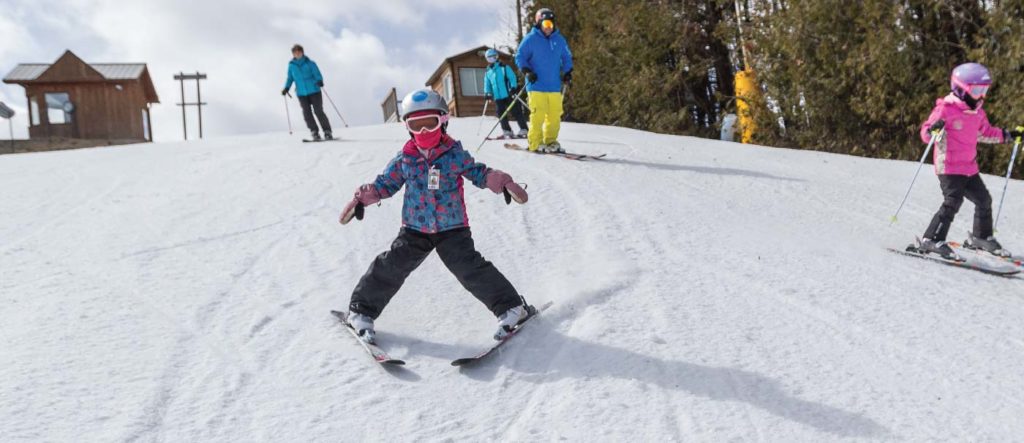 Child skiing down a bunny hill