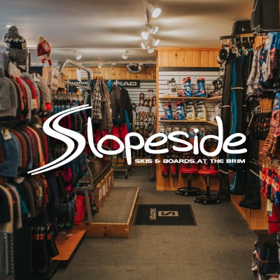 slopeside store, racks of hats, sweaters, and boots can be seen