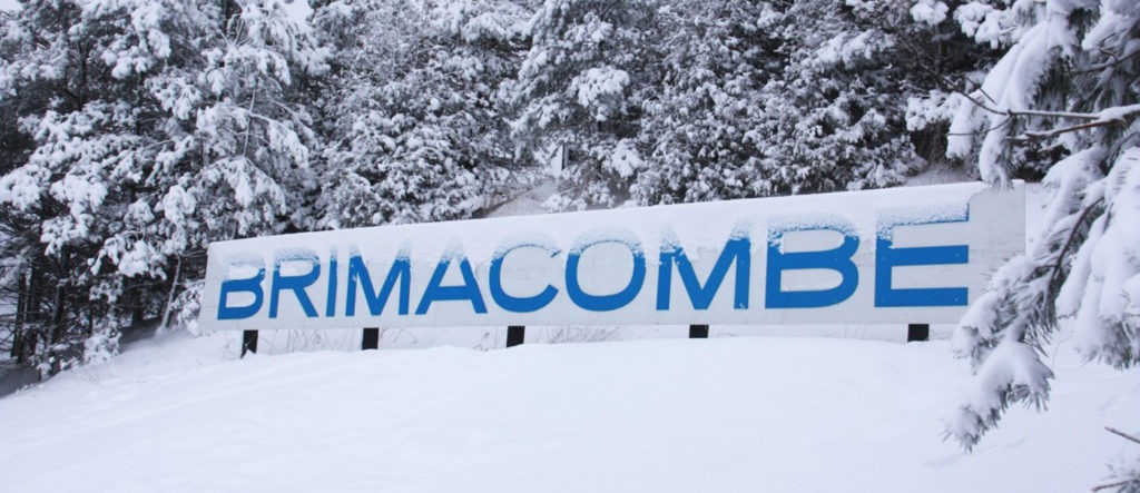 the brimacombe sign, surrounded by snow and snow covered trees