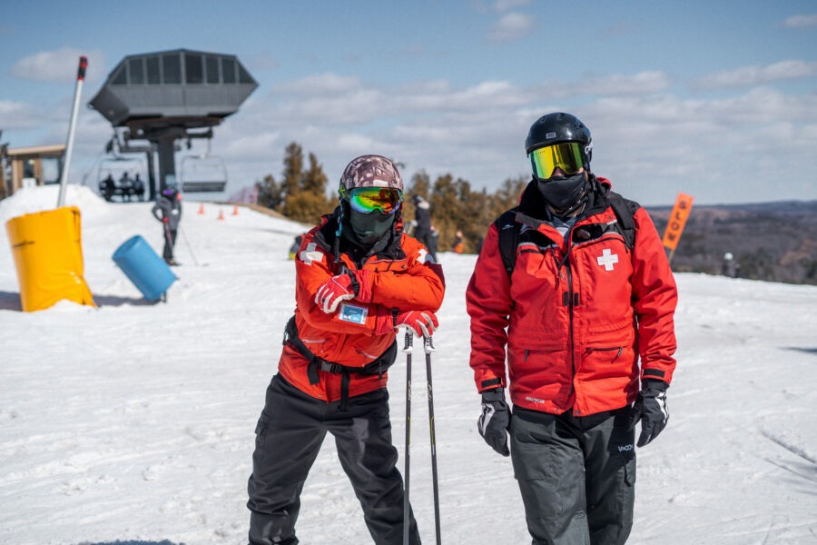 Two ski patrollers