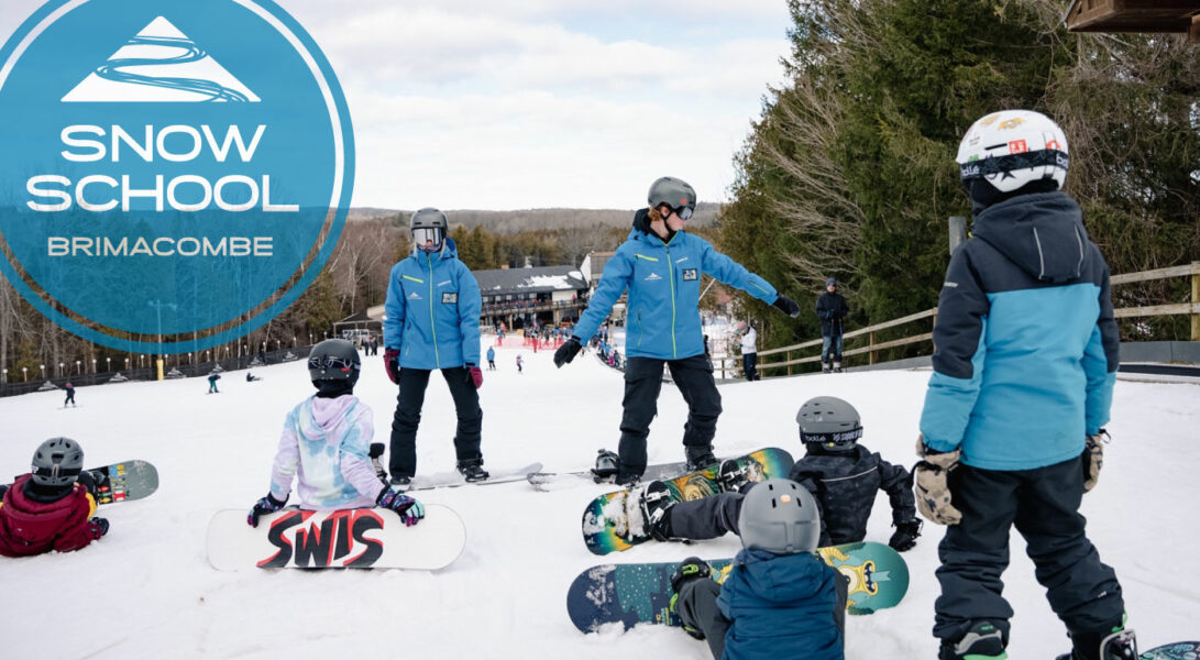 Snowboard Instructor with group of children learning to snowboard